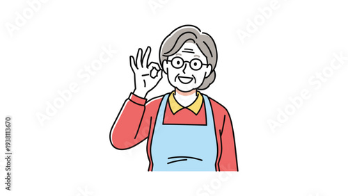 Friendly senior woman in a red shirt and blue apron gives a positive okay hand gesture with a happy pleasant smile.