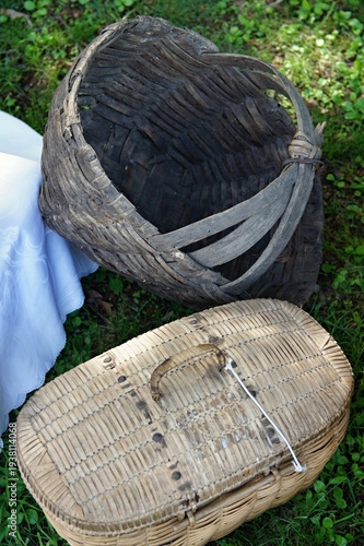 Wallpaper Mural Old wattle basket and vintage picnic hamper on grass Torontodigital.ca