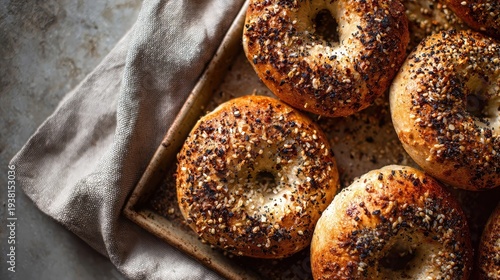 Wallpaper Mural Fresh everything bagels with golden crust and sesame seeds on rustic baking tray beside soft linen towel in warm morning kitchen light, cozy homemade breakfast concept Torontodigital.ca