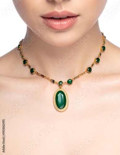 Close-up of a woman's neck, gold necklace with green gemstone pendant