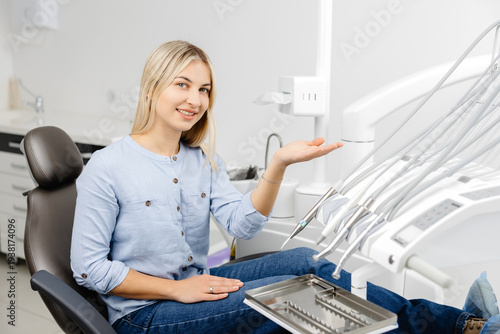 Young patient showing modern dental equipment sitting on dentist chair