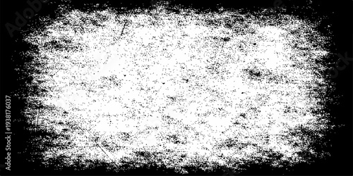 Abstract black and white grunge background featuring a dirty old wall texture with a rough stone surface and vintage paint splash design