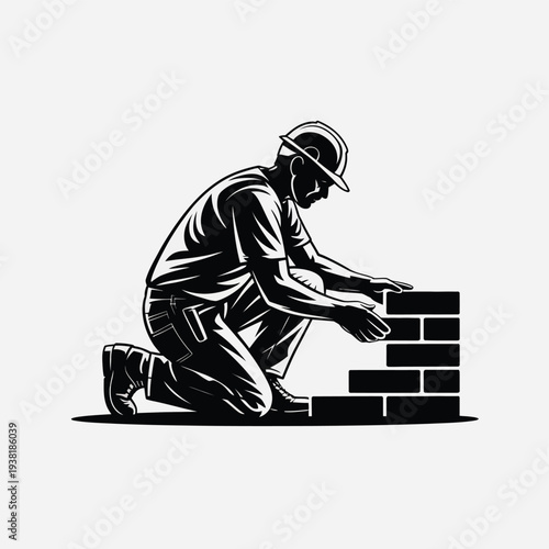 Construction worker building brick wall with hard hat and tool belt kneeling on ground
