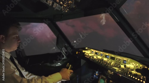 Professional male pilot navigates airplane with steering wheel making maneuver. Skilled captain guides airplane during lightning