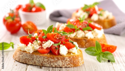 Toasted bread topped with tomatoes, white cheese, and basil on a rustic wooden surface
