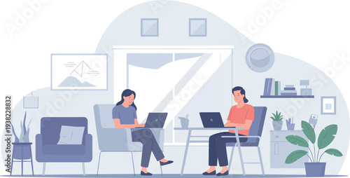 Two women working on laptops in a bright modern office space