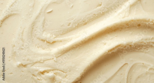 Close up of smooth vanilla ice cream texture with creamy swirls on a pale backdrop Copy Space