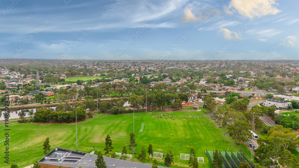Obraz premium Panoramic Aerial Drone view of Inner Suburbs of Melbourne housing, roof tops, the streets and the parks, the roads and trees of Ascot Vale Moonee Ponds Brunswick Essendon and Maribyrnong in VIC Victor