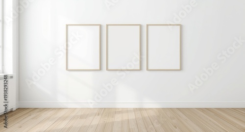 Cozy Scandinavian modern interior featuring white painted walls, wood flooring, three picture frames, and an empty wall for creative mockup