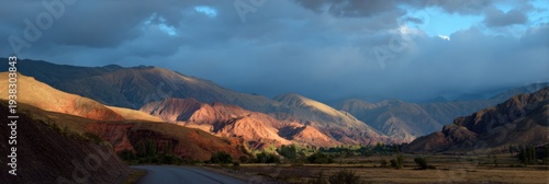 Road leading to colorful mountains sunset clouds valley panoramic arid landscape