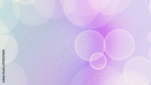 Shimmering pastel bokeh lights create an abstract purple and blue background.