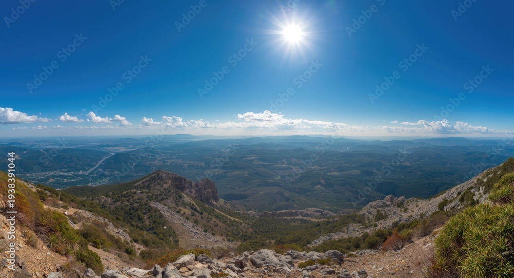 Fototapeta premium Panoramic view from a mountain summit under clear sky