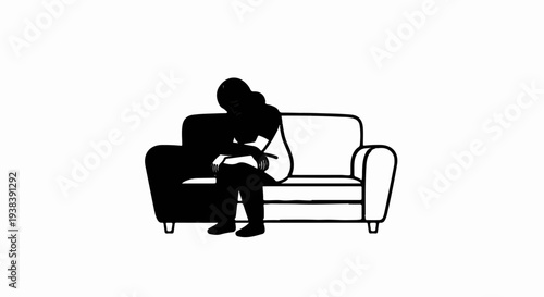 Lone figure in silhouette slumps on a simple couch, head bowed