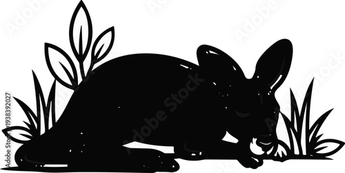 Silhouette of a rabbit eating a berry among grass and leaves