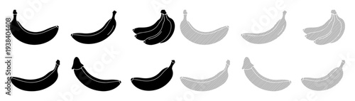 Juxtaposition of black and grey bananas against a white background, showcasing contrast and variety.