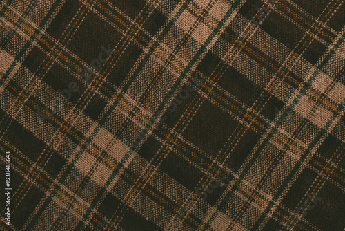 Pattern of brown and green plaid fabric created with woven yarn at a close range