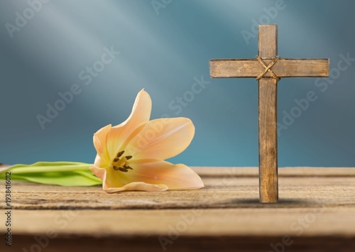Effects sunlight on wooden cross and flowers