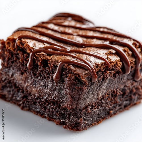 Close-up of a decadent, fudgy brownie with chocolate drizzle on a white background