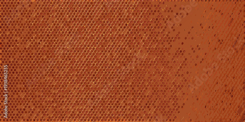 Close up of a textured orange surface with a perforated pattern