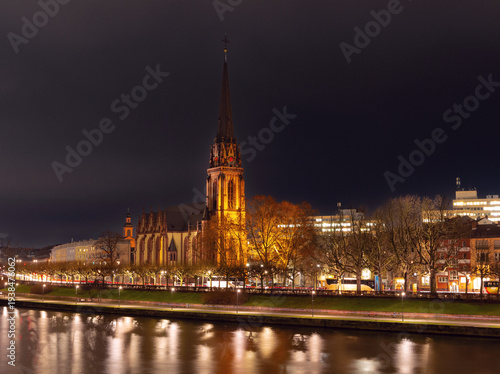 Illuminated cathedral and riverbank in Frankfurt am Main at night