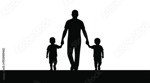 Father walking hand in hand with two young sons, silhouette