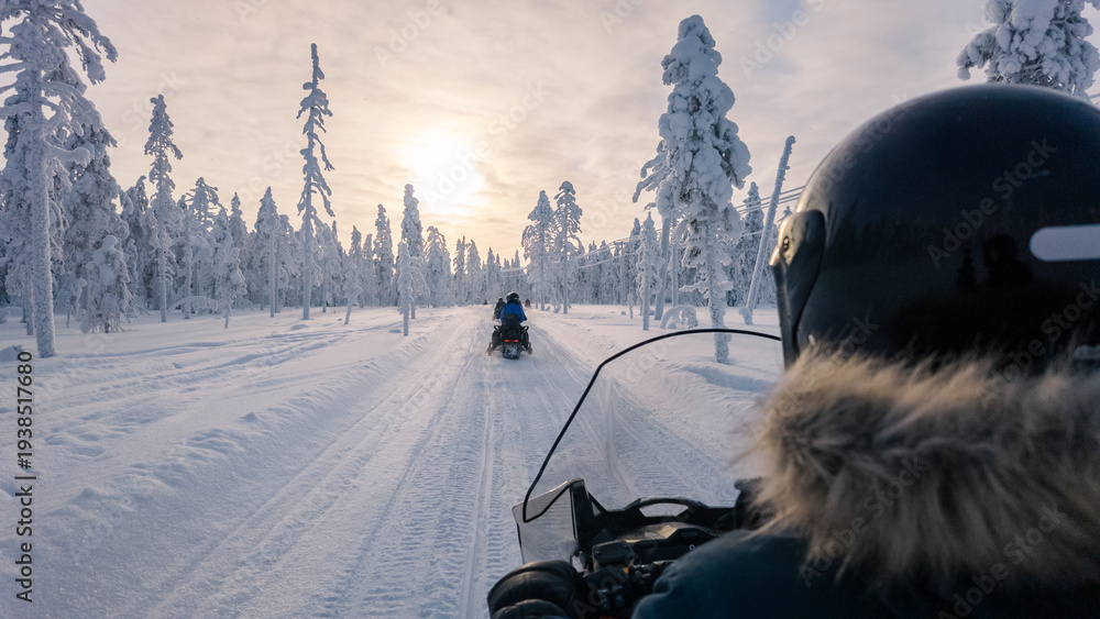 Obraz premium Thrilling snowmobile adventure through the winter wonderland of Akaslompolo, Lapland, Finland