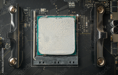 Принти на полотні used computer motherboard and installed cpu covered in grey thermal paste, textu