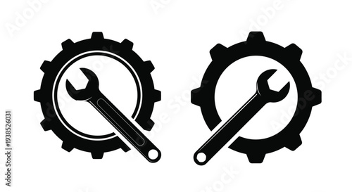 Two gear and wrench emblems in a striking black silhouette