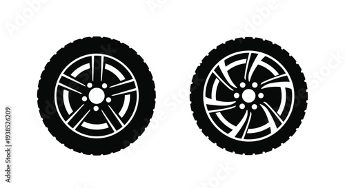 Two automotive tires with detailed rims a striking silhouette