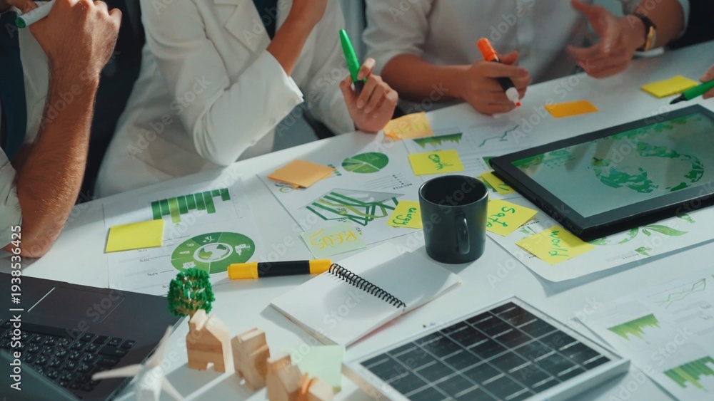 Naklejka premium Close up of business people hands write notes about sustainable energy and environmental idea. Group of diverse people taking a note and brainstorming about green tech. Focus on hand. Alimentation.