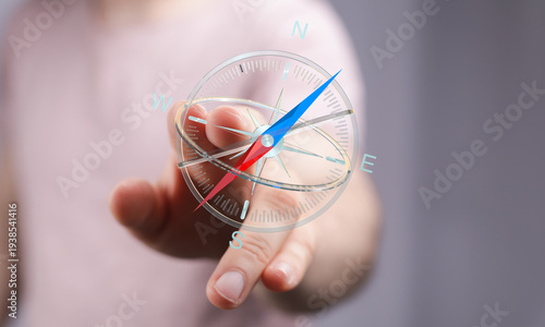 Hand holding a compass. Gui...