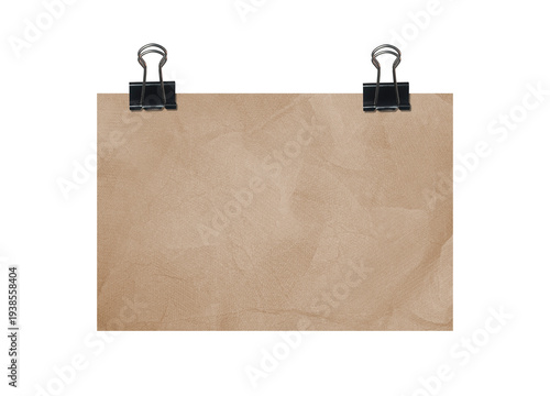 Brown crumpled paper sheet with black binder clips for organization concept
