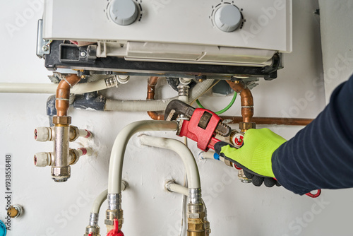 Plumber working at home, work at the heating installation at home