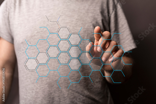 A person's hand touches a futuristic hexagon network, representing connection, technology, and innovation. Perfect for t