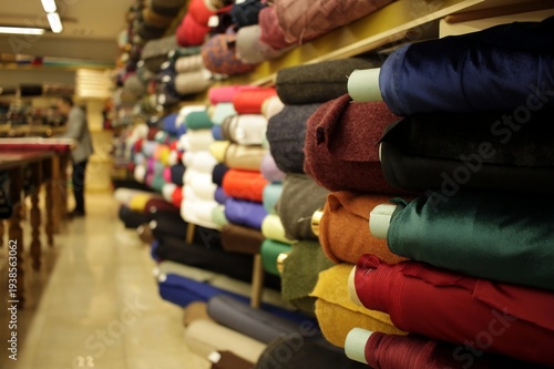 Wallpaper Mural Vintage drapery shop featuring stacks of colorful fabric bolts in a traditional setting Torontodigital.ca