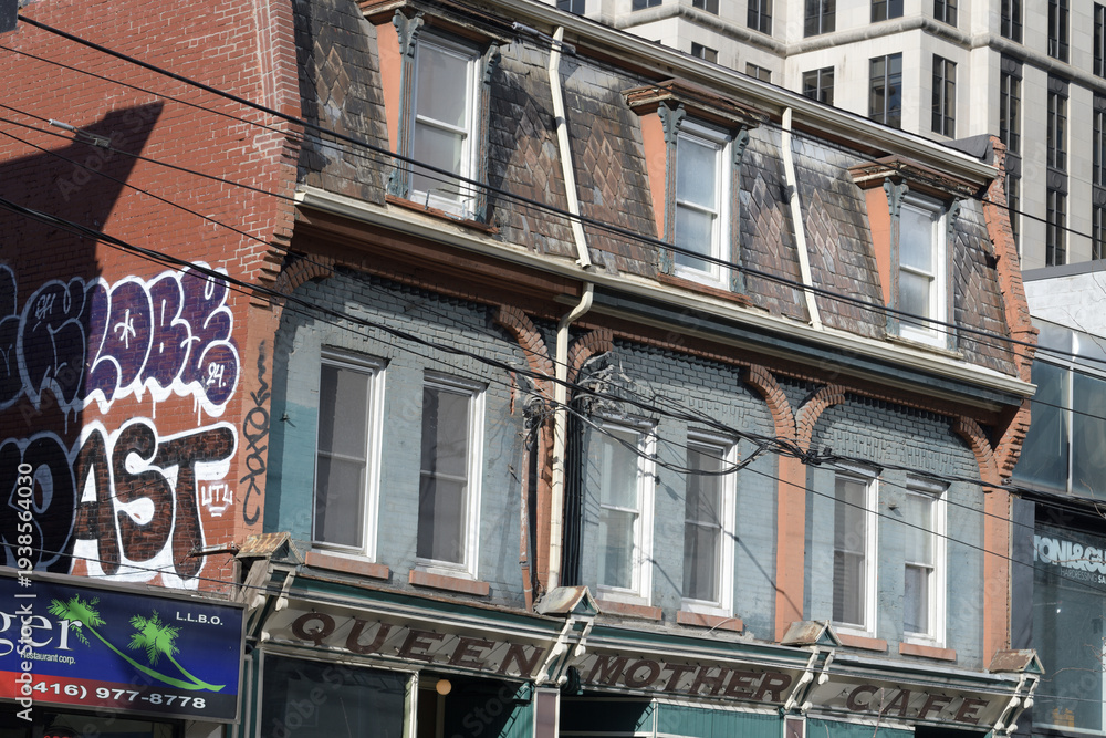 Naklejka premium exterior building facade and sign of Queen Mother Cafe, a restaurant, located at 208 Queen St W, Toronto