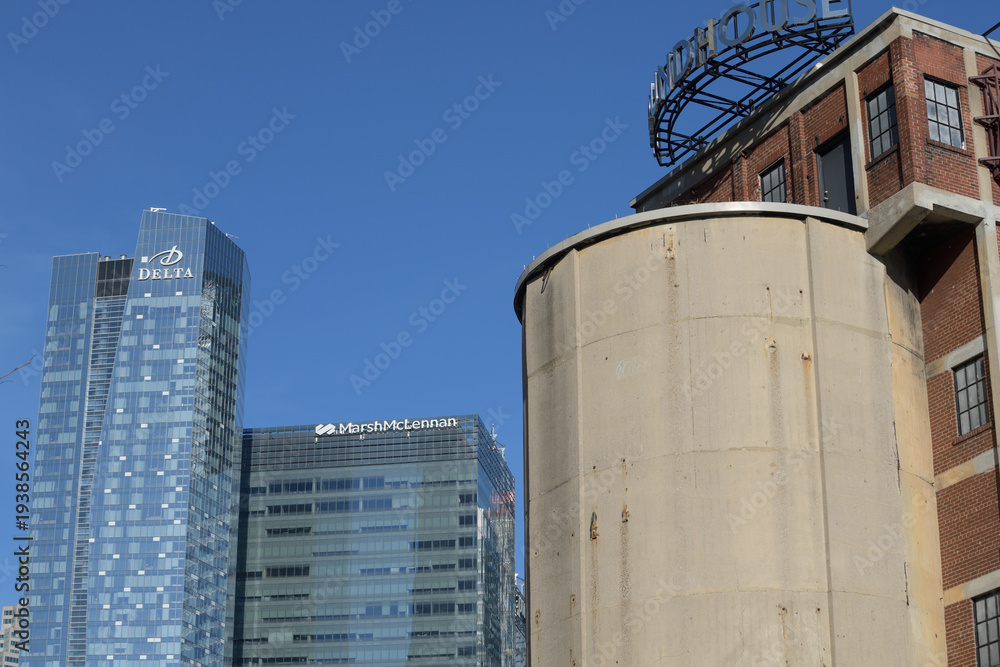 Fototapeta premium contrast of architectural structures: Delta hotel and Southcore Financial Centre business center (Marsh & Mclennan) and historic concrete coaling tower, John Street Roundhouse, Toronto