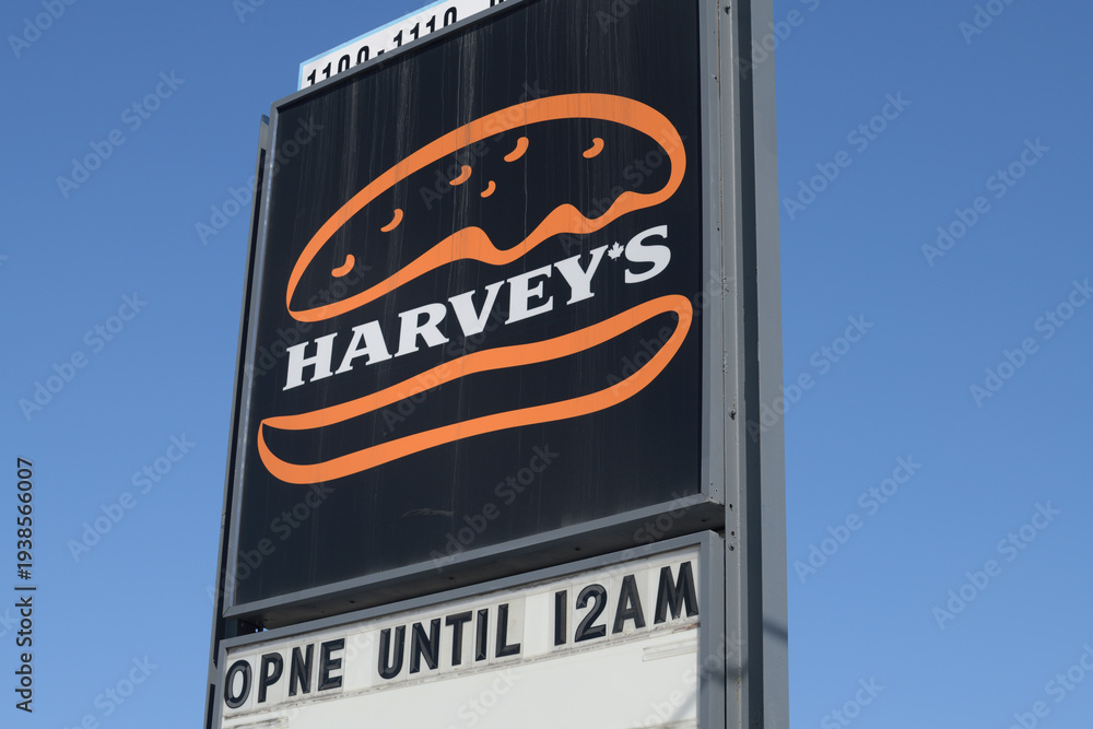 Fototapeta premium roadside pylon sign of Harvey's, a restaurant chain, located here at 1100 O'Connor Dr, Toronto