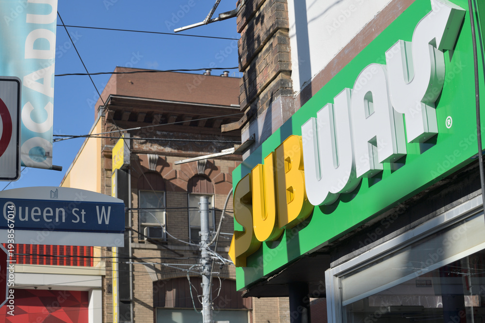 Fototapeta premium oblique angle view of Subway sign outside 267 Queen St W, southeast corner at Duncan St, Toronto