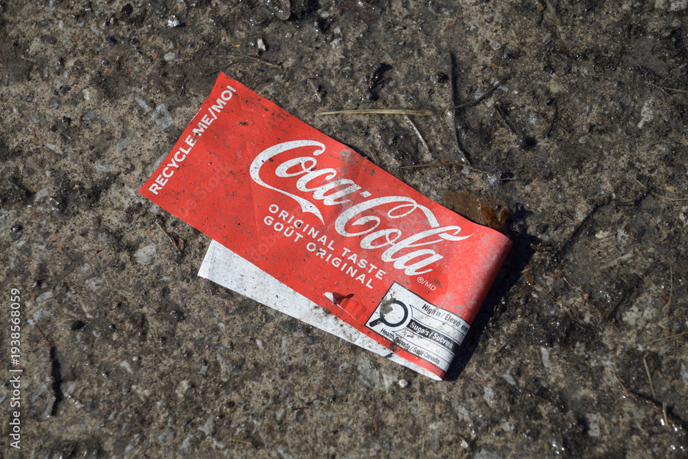 Naklejka premium grungy slightly defocused Coca-Cola label on a wet pavement in Toronto