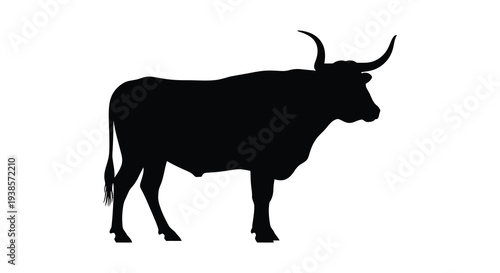 A striking black silhouette of a large bull with prominent curved horns stands in profile silhouette high quality professional