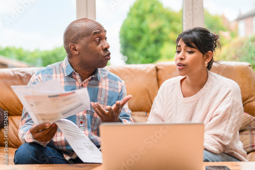 Discussion about finances between a man and a woman in a living room during the afternoon