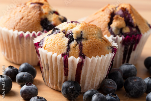Close Up Homemade Blueberry Muffins with Blueberry Juice Dripping Down Paper Cases