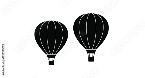 Two hot air balloons floating depicted in a dark striking silhouette