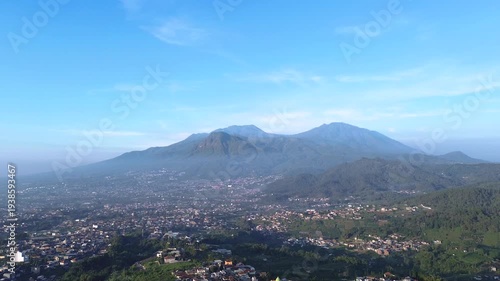  panoramic view of a city nestled in a lush, mountainous landscape