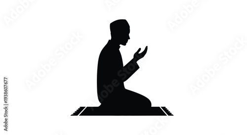 Silhouette of a man kneeling in prayer on a rug