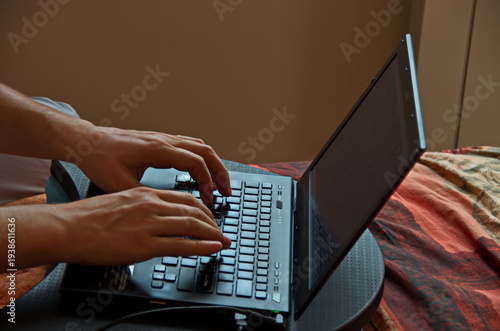 A view of an operator working on a notebook at home, Sofia, Bulgaria