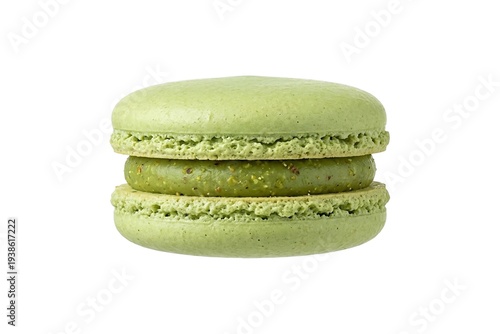 Single green pistachio macaron sweet sandwich cookie isolated on white background side view