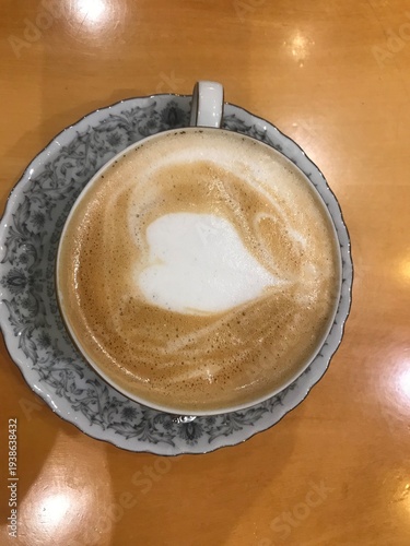 Top view of latte art heart in vintage porcelain cup