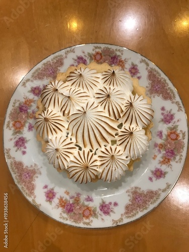 Title: Lemon meringue tartlet on floral pattern vintage porcelain plate